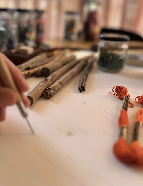 The artisan at work — hand-stitching a Vertical Works artwork